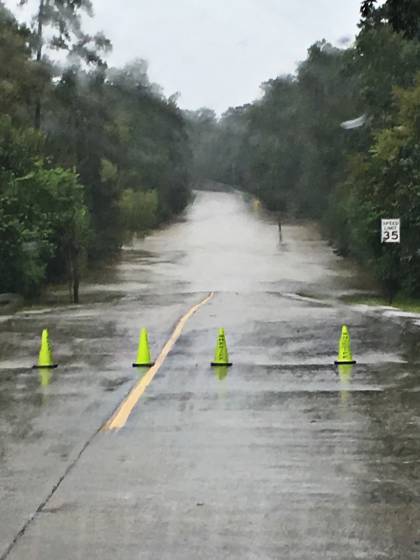A flooded road blocked by traffic cones during Hurricane Harvey