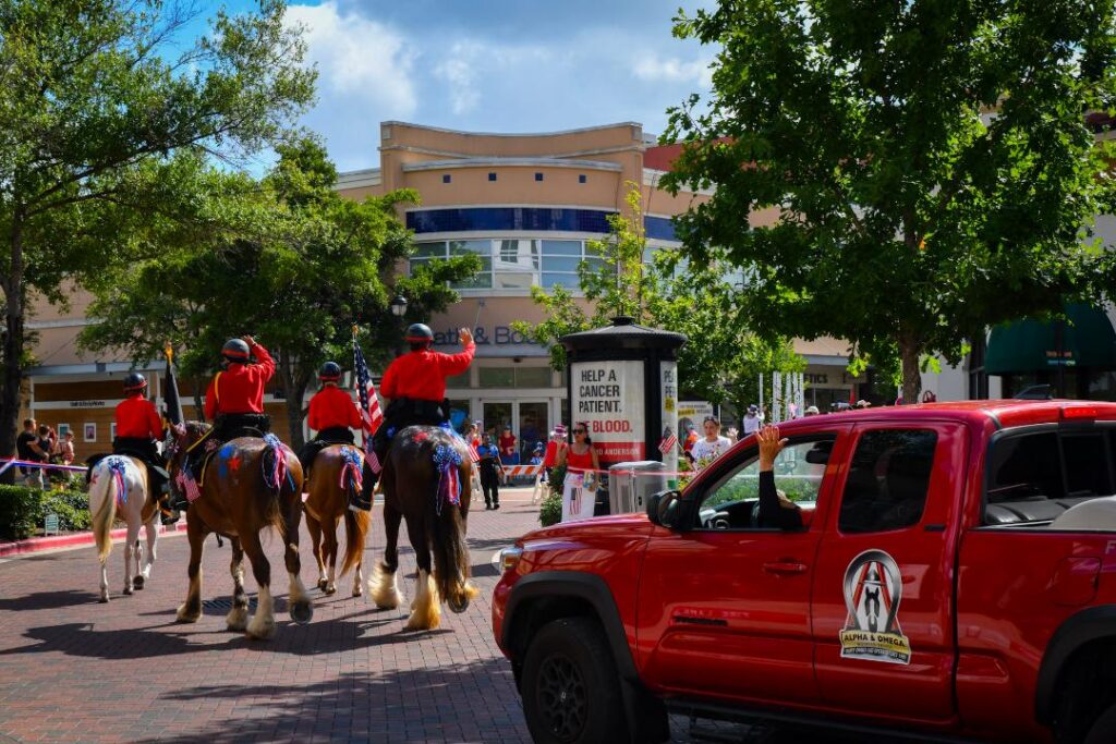 A&O mounted Troopers riding near a red branded patrol vehicle