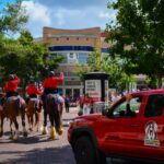 A&O mounted Troopers riding near a red branded patrol vehicle